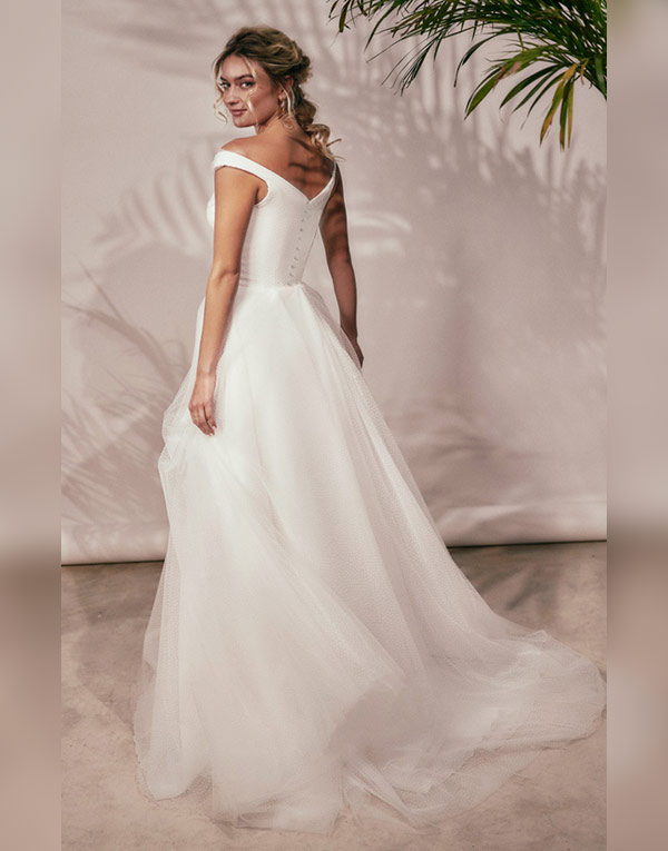 Misty: A beautiful silhouette, with an off the shoulder neckline and delicate polka-dot tulle